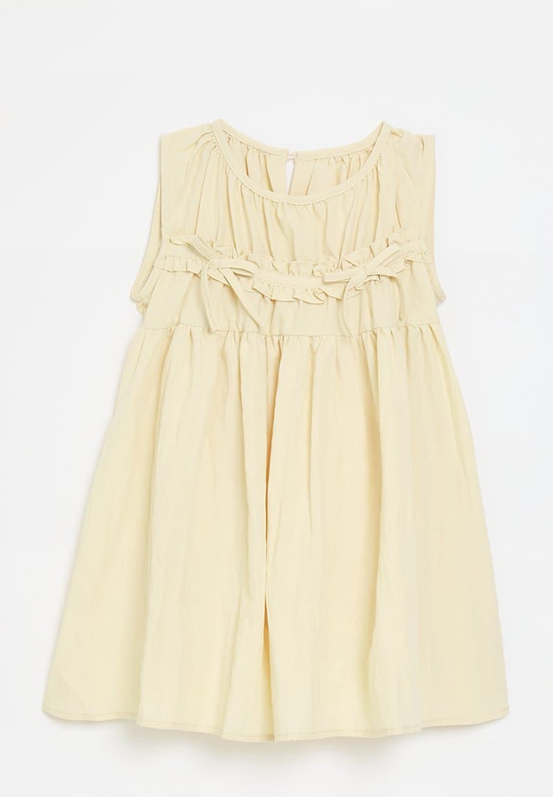 Smock bodice dress with dainty bows neutral